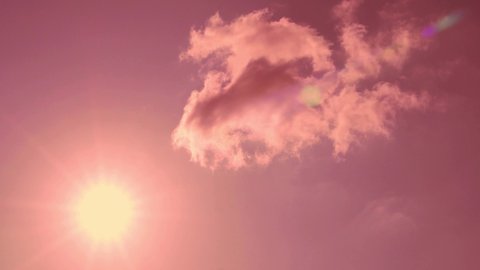 Pink Cloud Covers Sun in Coral Pink Lilac Clear Sky at Sunrise Down, Cloud Approaches Sun with Rays Highlights, Beautiful Timelapse. White Pink Cloud Transforms into Coral Pink Sky at Sunset.