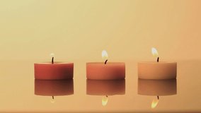 Animation of light spots over three candles. world meditation day and celebration concept digitally generated video.