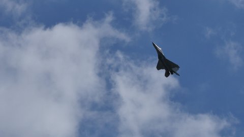 Moscow Russia AUGUST, 26, 2015 Russian military airplane supersonic in grey camouflage in flight in blue sky. Mikoyan-Gurevich MiG-29 Fulcrum of Russian Federation Air Force