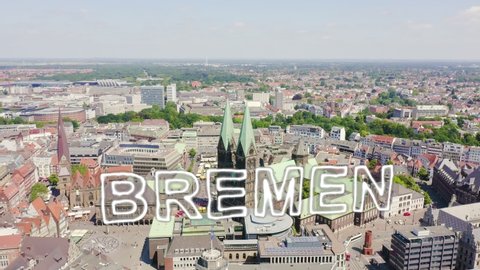 Inscription on video. Bremen, Germany. The historic part of Bremen, the old town. Bremen Cathedral ( St. Petri Dom Bremen ). View in flight. Neon white effect text, Aerial View, Point of interest