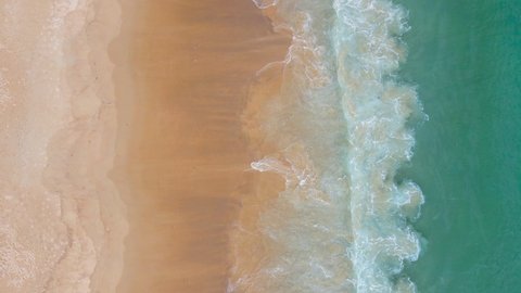 Nature video 4K Aerial view of drone. Scene of top view beach and seawater on sandy beach in summer. Nature and travel concept.