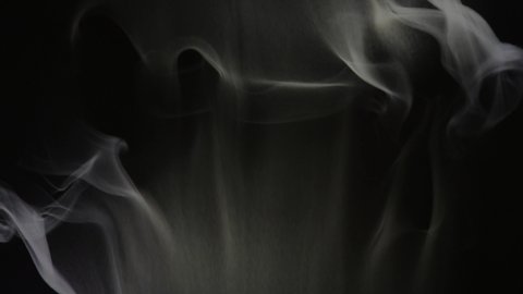 Smoke from bottom to top and top to bottom. Cloud of cold fog on black background. Realistic smoke best for using in composition, steam over black background. 4K UHD video footage 3840X2160.