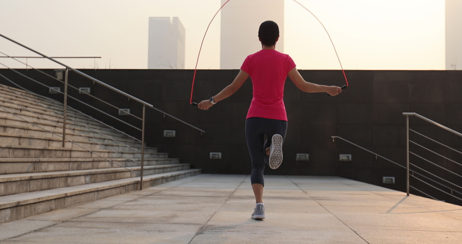 Fitness asian woman jumping rope Royalty-Free Stock Footage #1087910885