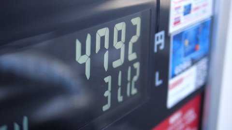Gas station fuel meter counter price. Close up while refueling a car. Increasing petrol costs. Number of Japanese yen