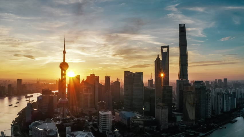 Aerial footage of city skyline and modern commercial office buildings in Shanghai at sunrise, China.