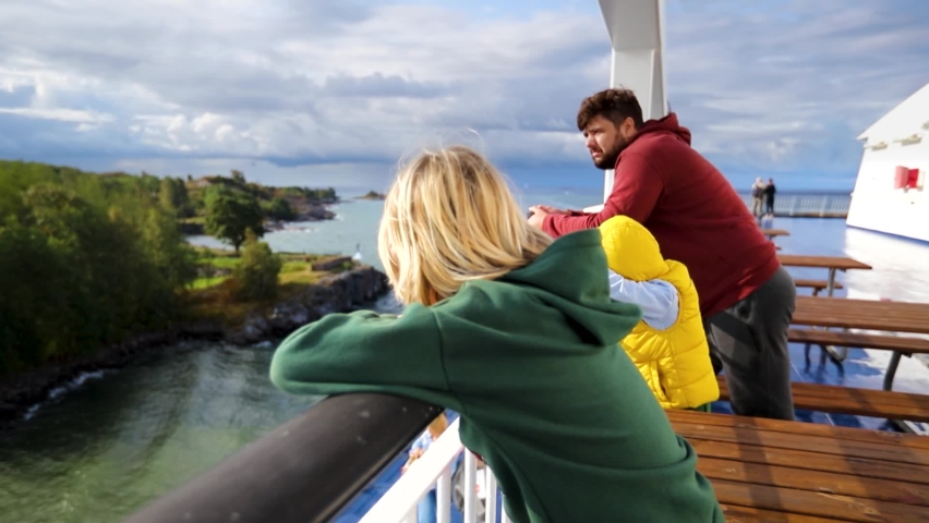 happy family, tourists sailing on cruise ferry through the Baltic Sea passing by the Vallisaari Island near the Helsinki Royalty-Free Stock Footage #1087913327