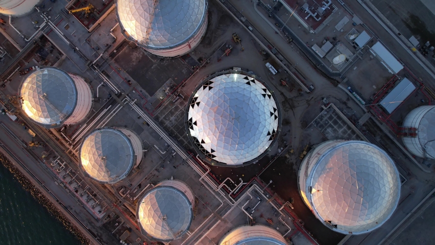 Oil storage tanks and pipes at the oil terminal during dusk or twilight