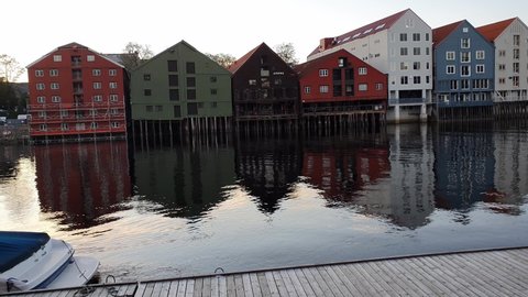 Old storehouses along the Nidelva, Trondheim, Norway Europe. Calm evening at a boat dock