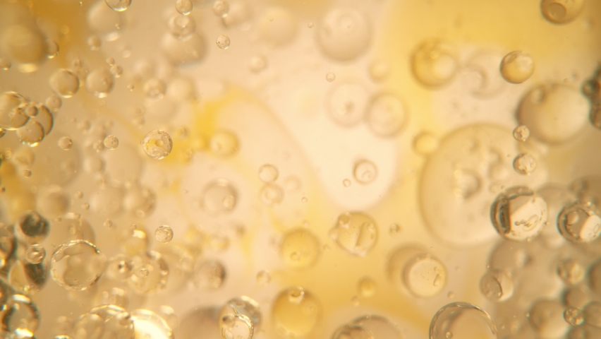Super Slow Motion Shot of Oil Bubbles on Golden Background at 1000fps. Shoot on high speed cinema camera. Royalty-Free Stock Footage #1087915505