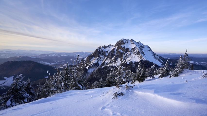 Rocky peak in winter landscape. Snowy mountain nature in the national park, zoom in