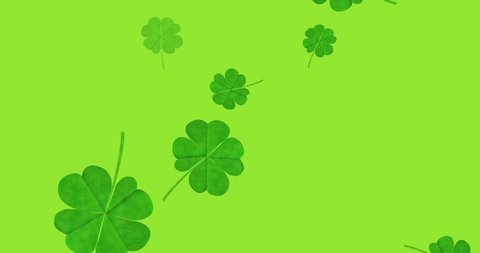 Animation of multiple clover leaves falling on green background. st patrick's day celebration and irish tradition concept digitally generated video.