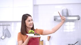 Young woman showing steak on a plate on mobile phone. Young woman show video blog about food healthy with mobile phone. Making photo and video of steak.