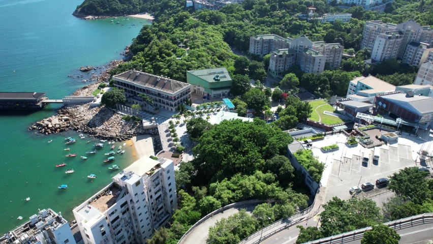 Stanley Market, a coastal town of Hong Kong, with traditional villages, beautiful scenery, water activities, beaches and islands, sea bay, pier and boats in-shore, aerial view