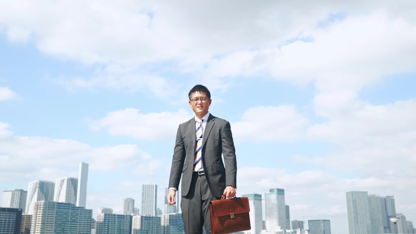 Jumping businessman in front of the city. Success of business. | Shutterstock HD Video #1087925487