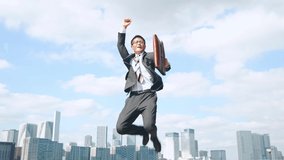 Jumping businessman in front of the city. Success of business. - Powered by Shutterstock - Get 15% off with code: PIKWIZARD15