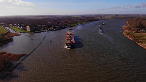 Zwijndrecht , Netherlands - 02 07 2022: Aerial Tilt Down View Of Millennium Ship Carrying Cargo Containers Along Oude Maas 