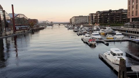 City Centre of Trondheim, Norway in calm evening light. Yachts and boats on the piers in River Nivelda