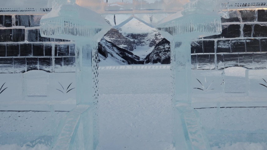 Walking through ice sculpture on lake Louise revealing Massive snow capped mountain landscape. Banff Royalty-Free Stock Footage #1087926729