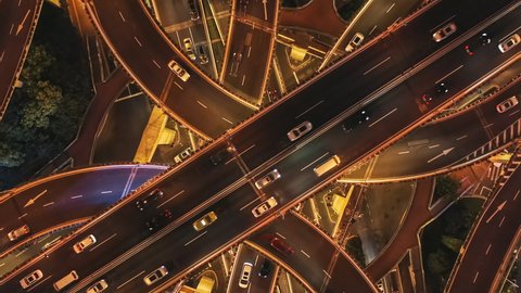 Aerial footage of busy traffic on viaduct in Shanghai at night, China. High angle shot of traffic in China.