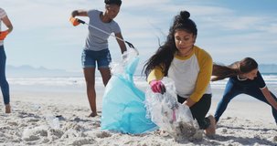 Animation of globe icons over diverse female volunteers picking up rubbish on beach. eco conservation volunteers, beach clean-up concept digitally generated video.