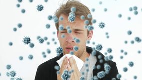 Animation of virus cells floating over caucasian man having running nose. global covid 19 pandemic concept digitally generated video.