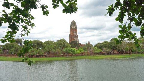 Wat Rama at Ayutthaya Historical Park is an old ancient site, Thailand with reflections of water and many clouds
