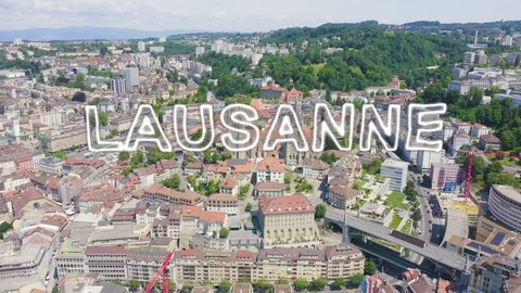 Inscription on video. Lausanne, Switzerland. Cathedral of Lausanne. La Cite is a district historical centre. Neon white effect text, Aerial View, Departure of the camera