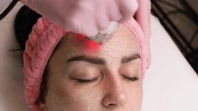 Cosmetologist making biolifting rf-lifting procedure. Rejuvenating skin, preventing aging, woman getting stimulating beauty facial treatment. hardware cosmetology in modern clinic. 4 k video