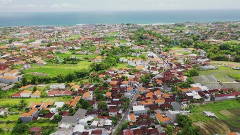 Aerial Tilt up 4k footage of the centre of Canggu, Bali. Rice fields in Canggu