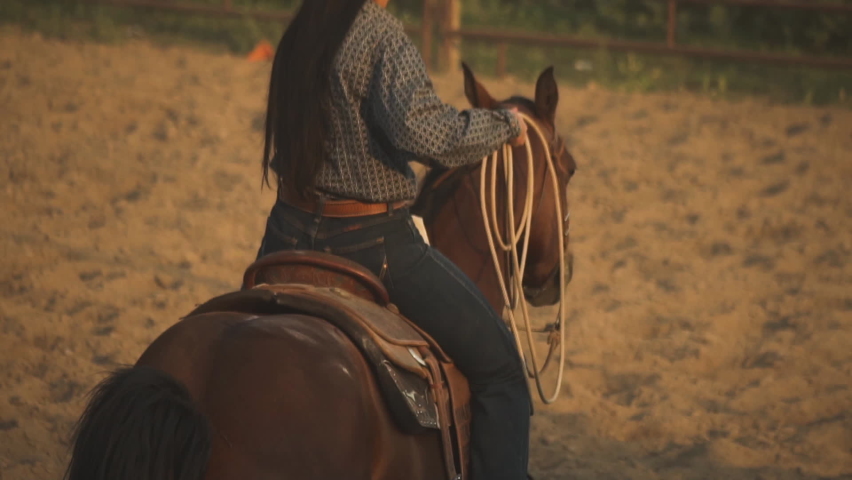 Montana , United States - 02 23 2022: cowgirl horse racer wrapping a loop rope at Montana Rodeo circuit
