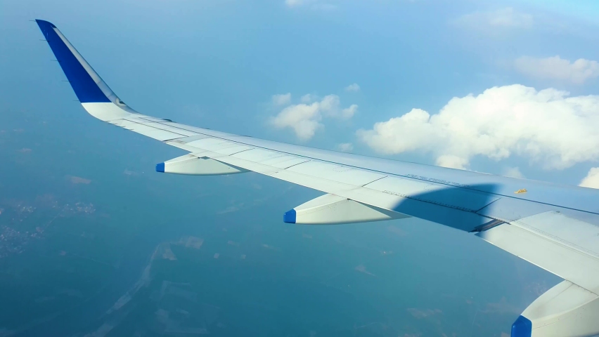 View of airplane wing from window, flying mid air. Royalty-Free Stock Footage #1087944309