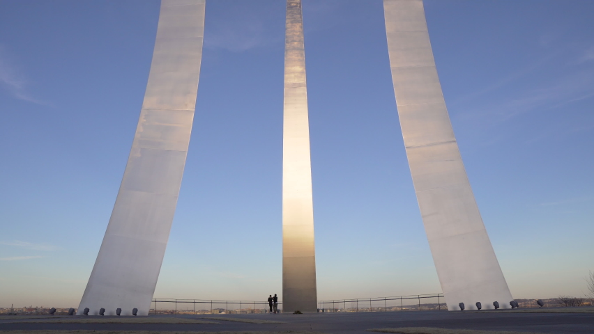 Arlington, Virginia USA- February 21st, 2022: A 4k sunset video of tourist in-front of the metal pillars of the Air Force Memorial in Arlington Virginia.