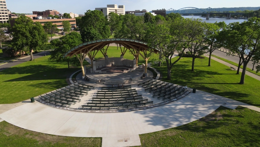 Drone view of event venue in park in La Crosse, Wisconsin, on a beautiful summer day. Newly completed renovations. Mississippi River and bridge seen along the side. 