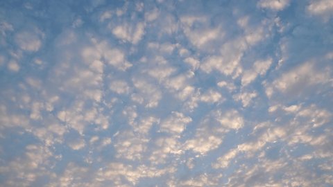 Blue sky background with clouds.
Altocumulus clouds Time Lapse.