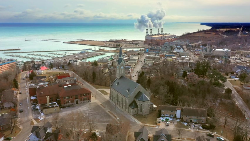 Close flyby of church steeple, with view of small town America

