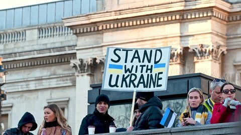 LONDON - FEBRUARY 27, 2022: Protesters hold Stand With Ukraine sign at demonstration against the war in Ukraine