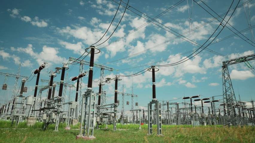 Power Grid Station. Electrical Distribution Station, Transformers, High-voltage Lines In Sunny Summer Day. Time Lapse, Timelapse, Time-lapse, 4K.