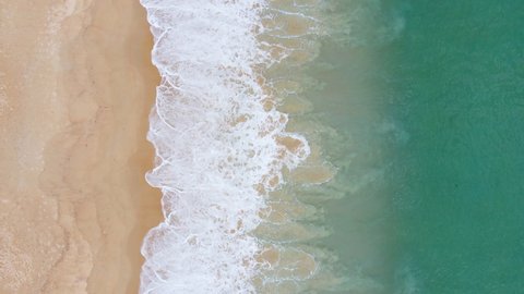 Nature video 4K Aerial view of drone. Scene of top view beach and seawater on sandy beach in summer. Nature and travel concept. Shot on drone high quality camera. 