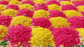 HD video of beautiful pattern or texture created with colorful rice for worship during housewarming function in Indian culture