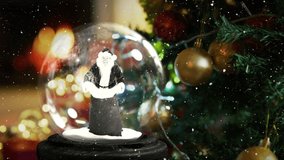 Animation of christmas snow globe with santa claus and christmas tree. christmas, tradition and celebration concept digitally generated video.