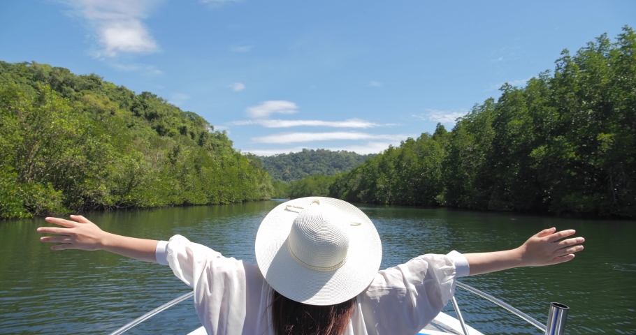 Rear view of women tourist enjoying nature on the boat cruise in water through mangrove forest along the Klong Chao canal in Ko Kut, Koh Kood islands Thailand. Travel concept. | Shutterstock HD Video #1087960045