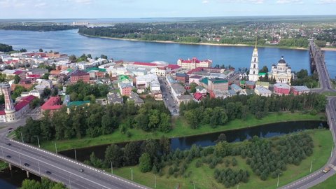 Aerial view of Russian city of Rybinsk in Yaroslavl Oblast overlooking historical area with five-domed Orthodox Transfiguration Cathedral on bank of Volga river and bridge on sunny summer day