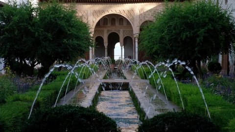 Granada, Spain, 31.08.2021: The Generalife Gardens, Alhambra Granada. Water flowing from the fountains. Moorish Architecture. Unesco Spain. Travel in time and discover history. Holidays. 
