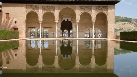 Granada, Spain, 31.08.2021: Garden of the Partal,  Alhambra Granada. Reflection in the water. Moorish Architecture. Unesco Unesco World Heritage Spain. Travel in time and discover history. 
