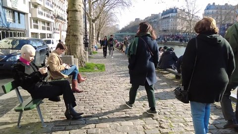 paris,france - march 05 2022 : slow motion tourists and lifestyle in Paris , sunny backlight