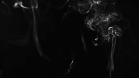 white smoke or dust, wavy and swirly on black background. perfect for compositing eg. hot tea, cigarettes or other smoking things