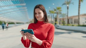 Young woman smiling confident watching video on smartphone at park