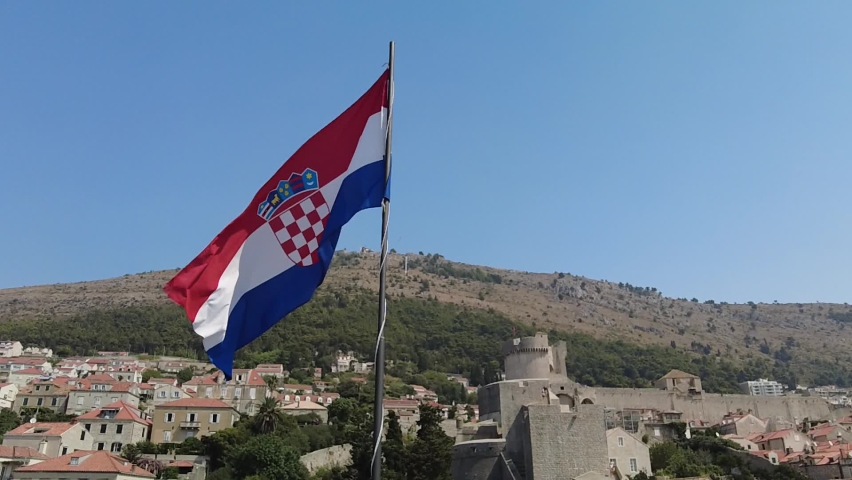 Aerial view on Dubrovnik walls of Croatia with Croatian flag. View of Fort Lovrijenac fortress Dubrovnik UNESCO Venetian town of Croatia in Dalmatia
