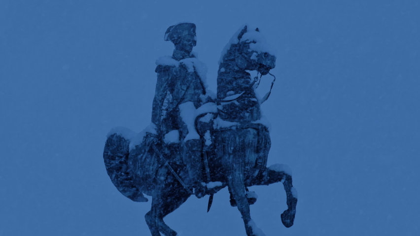 Old Military Statue In Snowfall Late In The Day