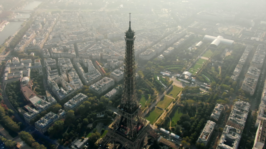 Aerial Panorama of Paris Cityscape with Eiffel Tower on Champ de Mars and Seine River. Landmark French Monument in Historic City Center. Most Visited Travel European City. 4K drone top down orbit shot | Shutterstock HD Video #1087974335